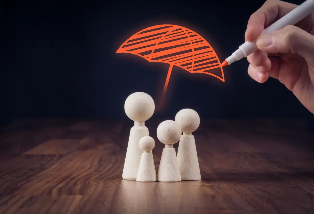White pawns under an umbrella representing a family, where one of the members has life insurance after carefully considering which type is required.